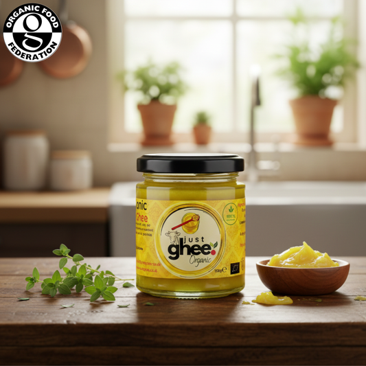 Organic Original Cow Ghee in a glass jar with a wooden bowl of ghee on the kitchen counter, showcasing pure goodness.